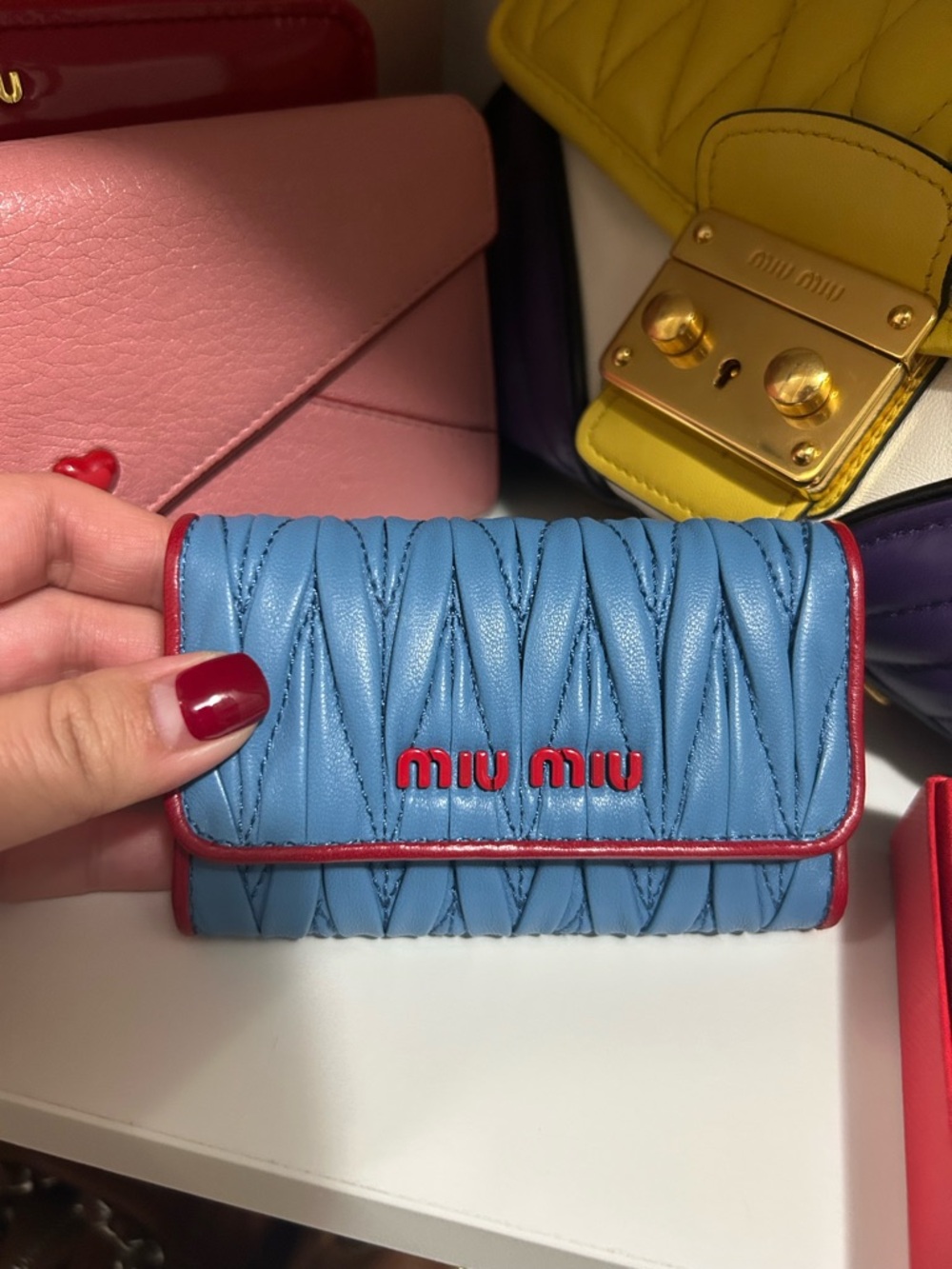 Authentic Miu Miu Blue Quilted Leather Key Case with Red Trim and Logo